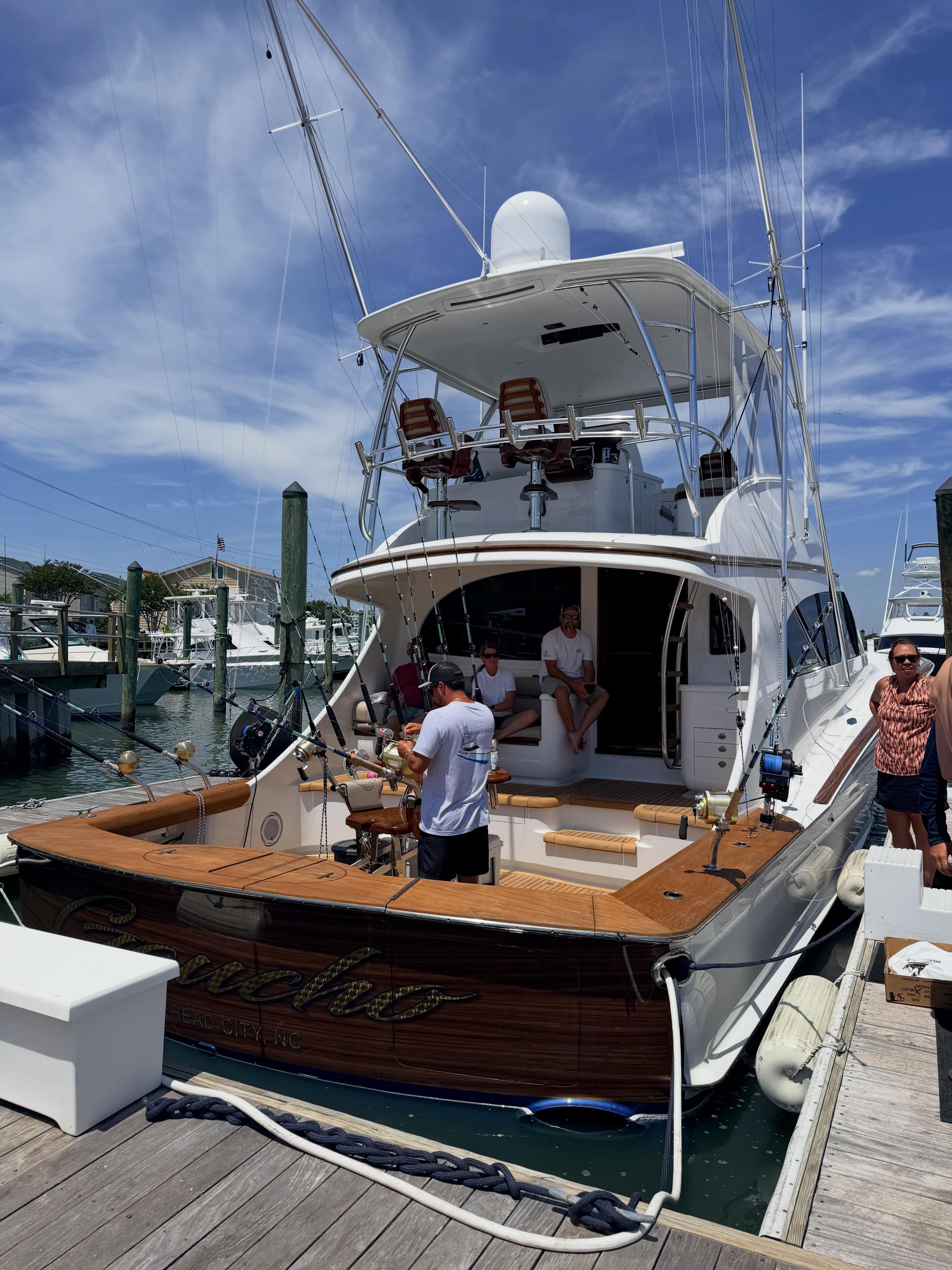 Sportfishing boat with a wood-grain wrapped transom at Morehead City Yacht Basin